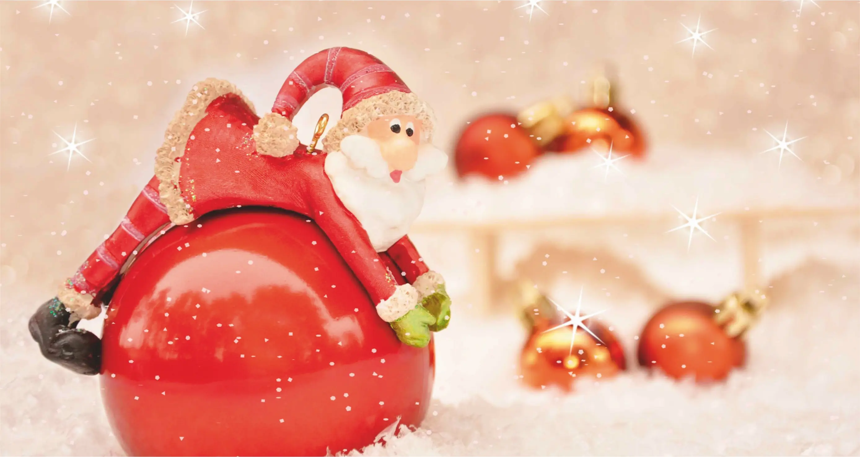 Kleiner Weihnachtsmann auf roter Kugel